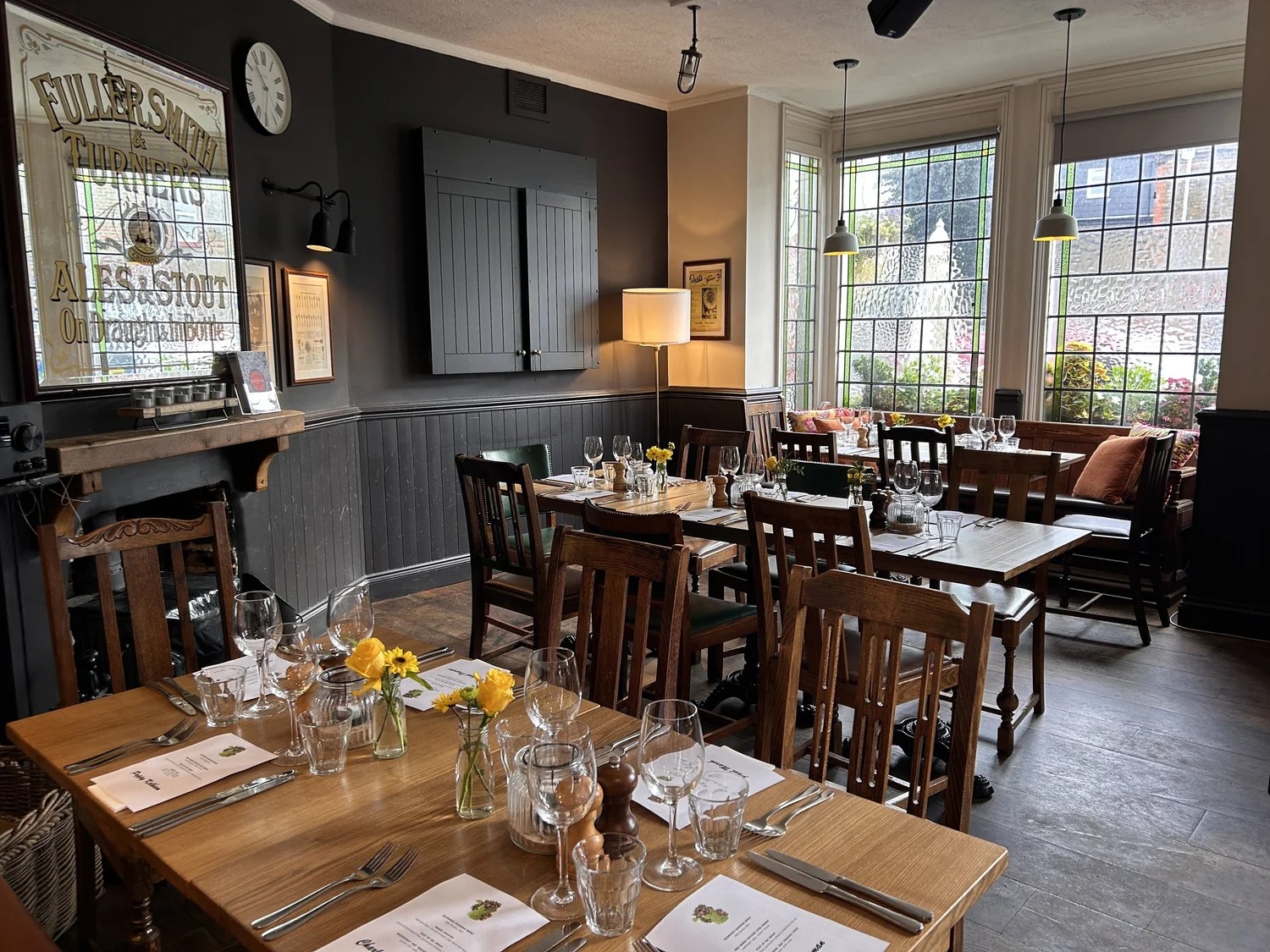 The dining room set with menus and yellow flowers